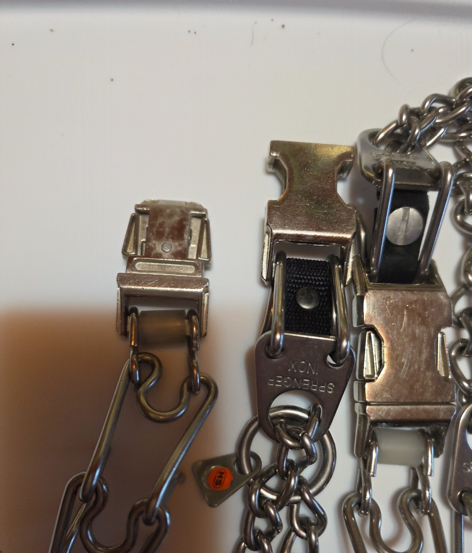 Third-party quick-release buckle shown open beside the snapped-shut one